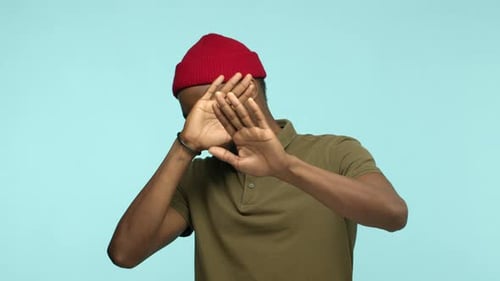 Man in Red Beanie Puts Hands Up