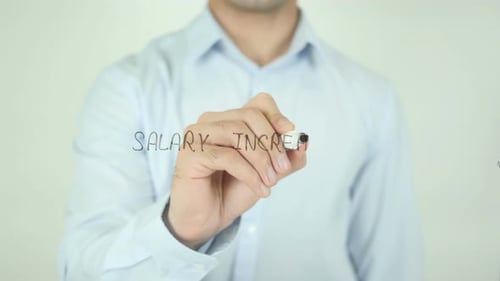 Man Writes Salary Increase on Clear Surface