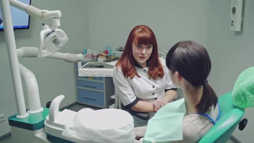 Dentist Talking to Patient in a Dental Office
