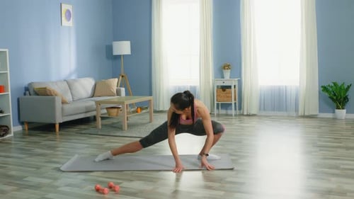 Young Woman Doing Stretching Exercises at Home