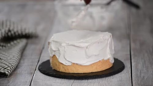 A Confectioner Prepares a Cream Cake, Dessert on a White Table in the Kitchen, The Concept of Home