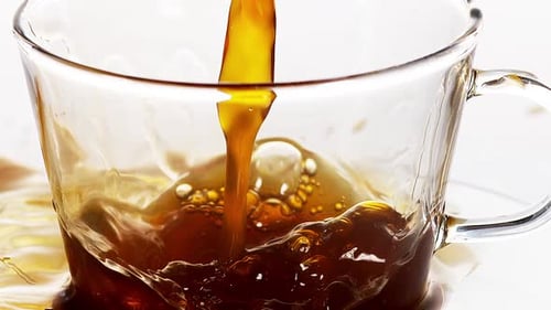 Close Up of Coffee Pouring into Clear Mug