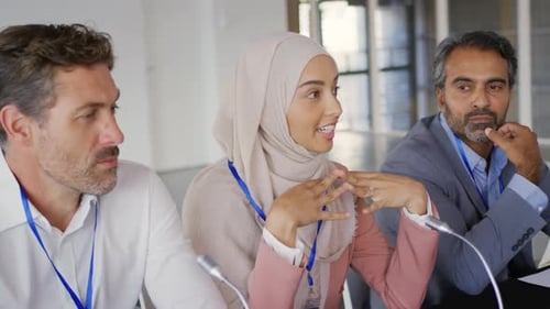 Woman Speaking at Conference with Colleagues
