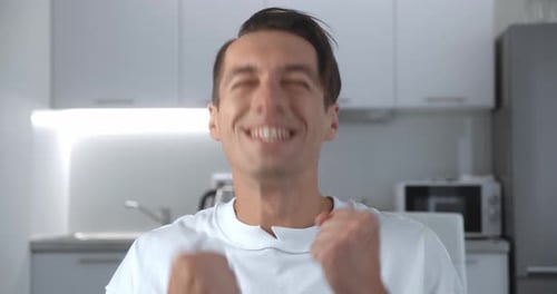 Young Man Reacts with Surprise and Celebration