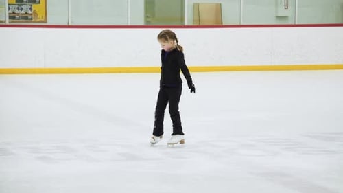 Girl Figure Skating on Indoor Ice Rink