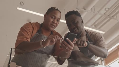 Coworkers Viewing Smartphone in a Workplace Setting