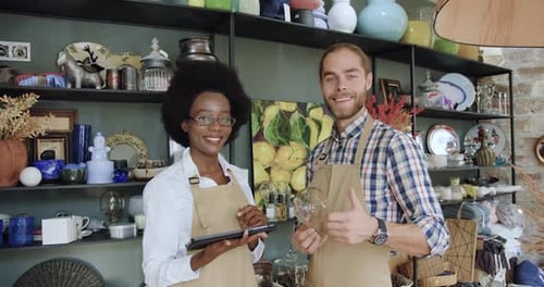 Mixed Race Sellers which Standing in front of Camera in Cozy Gift Shop