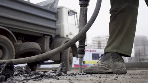 Two Adult Men Work. Destroy the Old Asphalt Puncher. Build New Road