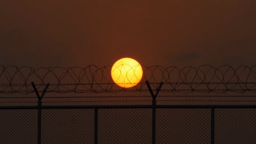 Barbed Wire Fence at Sunset
