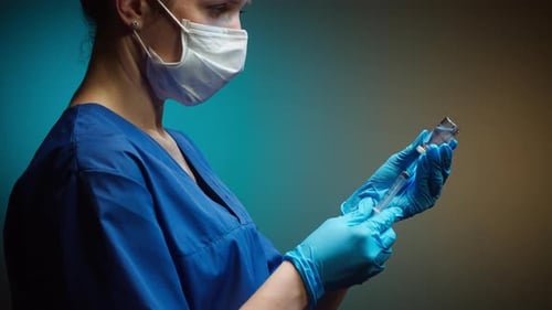 Medical Professional Filling Syringe with Medicine
