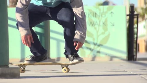 A young man skateboarding.