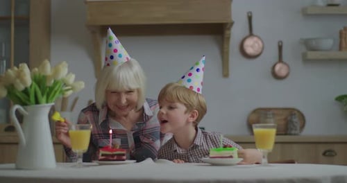 Grandmother and Child Celebrate Birthday Together Indoors