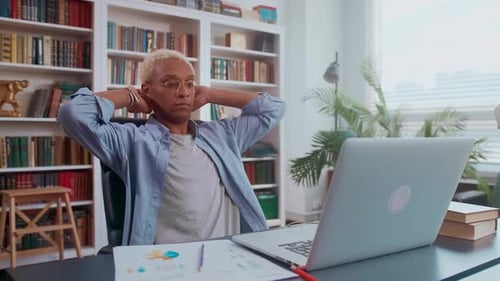 Man is Resting in the Office with His Eyes Closed and His Hands Behind His Head