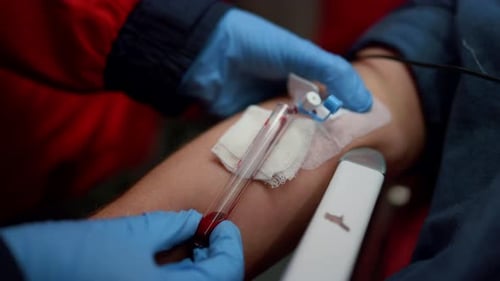 Medical Professional Drawing Blood from Patient via IV