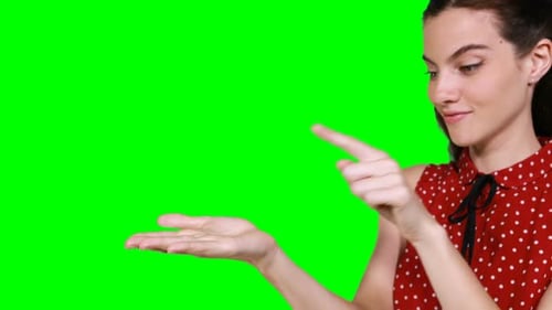 Smiling Woman Presenting on Green Screen Background