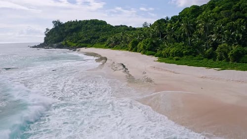 Aerial Drone Low Altitude Fly Above Tropical Sandy Beach with Ocean Waves at Mahe Island Seychelles