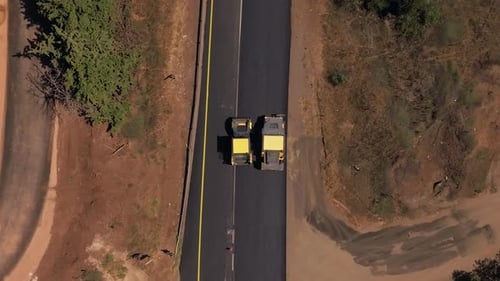 New road paving pressed by a road roller, Top down aerial view.