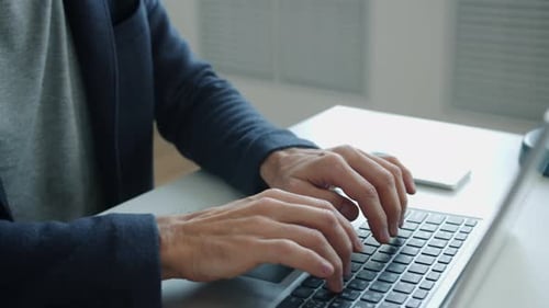 Close-up of Mature Businessman Using Laptop Typing Working at Business Project