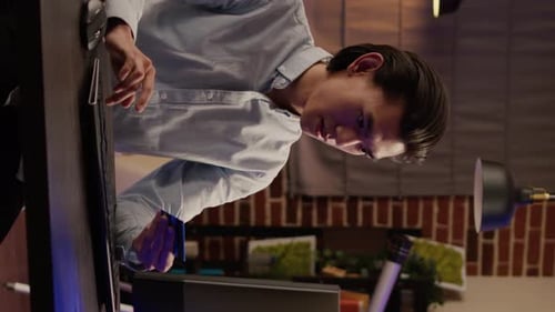 Young Adult Types at Computer Holding Credit Card