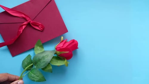 Romantic Rose, Gift, and Envelope on Blue Background