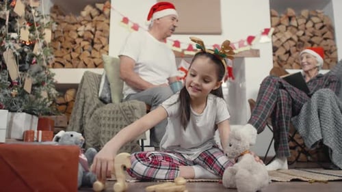 Girl Playing with Toys at Christmas with Grandparents