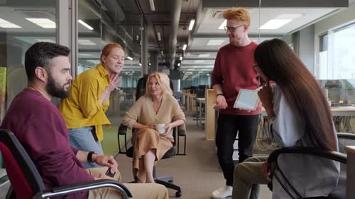 Team Discussing Data on Tablet in Modern Office