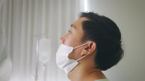 Medical Worker in Ppe Suit Swab Testing for Covid19 Sample From Mouth of Infected Man in Hospital