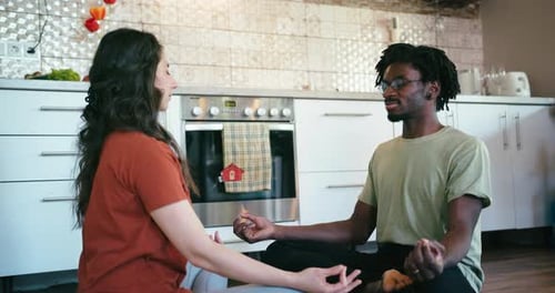 Couple Meditating and Laughing Together in Kitchen