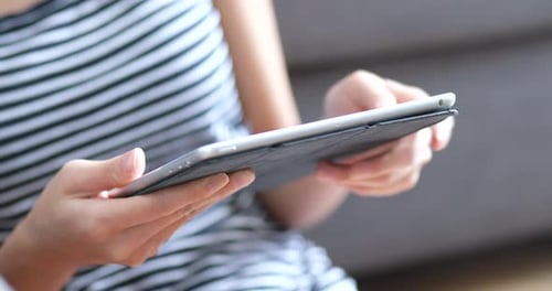 Close Up of Young Adult Using Tablet at Home