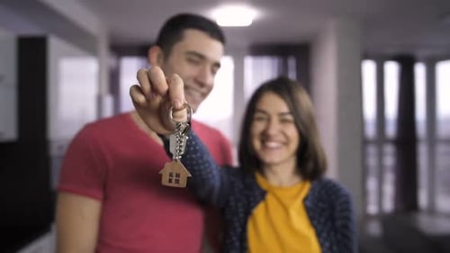 Happy Couple Holds Keys to New Home Together