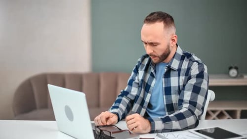 Man Working on Laptop at Home Office Desk