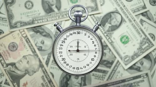 Stopwatch Ticking on US Dollar Currency