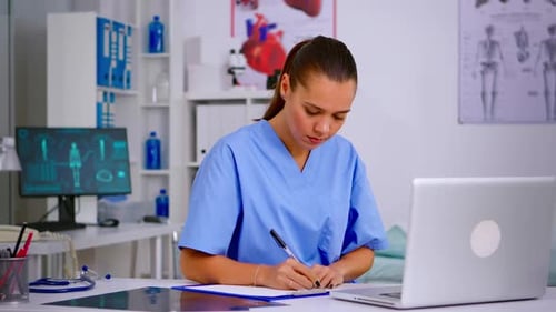 Woman Medical Professional Working at Desk in Office