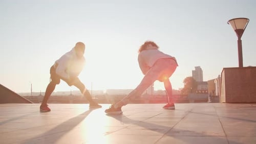 Athletic People Stretching Outdoors on Sunny Day