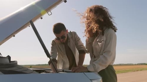 Couple With Car Trouble on a Rural Road