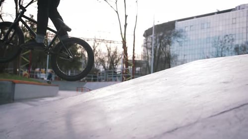BMX Rider Doing Tricks in Street Plaza Bicycle Stunt Rider in Cocncrete Skatepark Super Slow Motion
