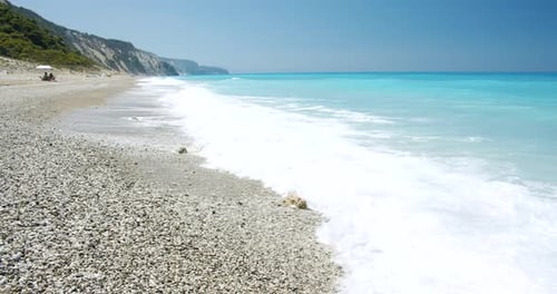 Beautiful Long Beach Waves with White Foam and Blue Sea