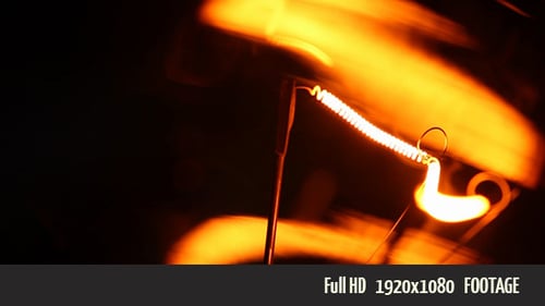 Glowing Lightbulb Filament Close Up in the Dark