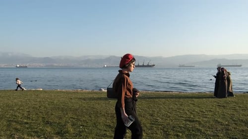 Stylish Woman Walking by the Water on Sunny Day