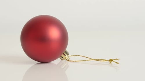 Red matte color bauble close-up 4K 2160p 30fps UltraHD footage - Tilting over Christmas ornament on