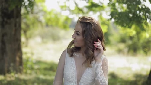 Beautiful and Lovely Bride in Wedding Dress in the Park. Slow Motion