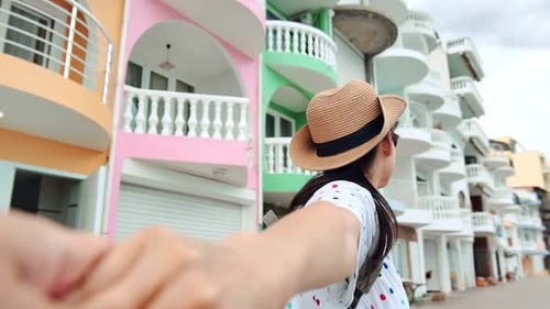 POV Shot Smiling Tourist Woman Holding Male Hand Walking at City Street Enjoying Holiday Travel