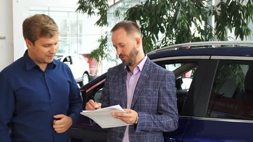 Man Signs Contract for New Car Purchase