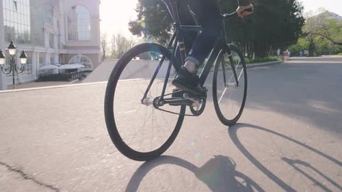 Tracking Shot of Hipster Man Riding Fixed Gear Bicycle in Park