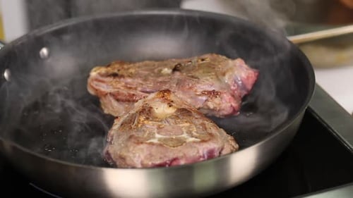 Juicy Steaks Sizzle in Frying Pan