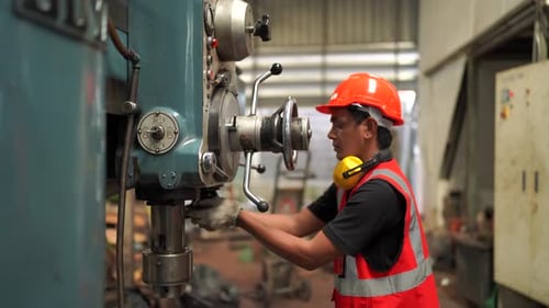 Industrial engineer worker operating control panel system at manufacture plant