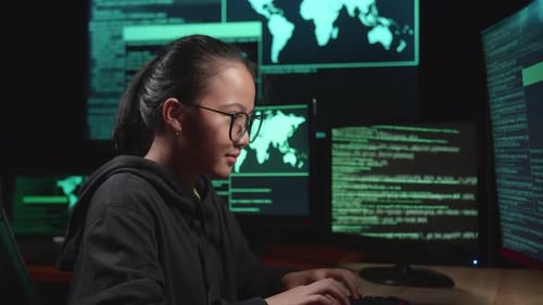Asian Young Girl Hacker Hacking With Multiple Computer Screens In Dark Room