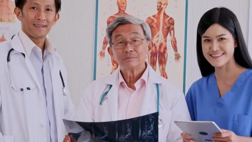 Doctors and Nurse Study X-Ray in Hospital