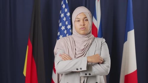 Woman in Suit Standing Before International Flags