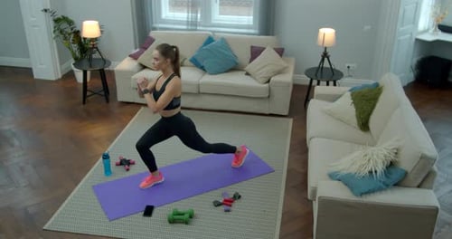 Woman Doing Lunges on Yoga Mat in Home